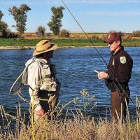 Image of A Official legal person talking with fisherman about fishing law
