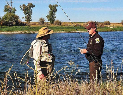 Image of A Official legal person talking with fisherman about fishing law