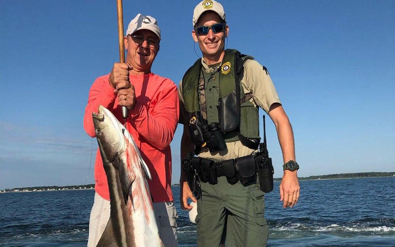 Image showing two fishermen with fishing rod and fish