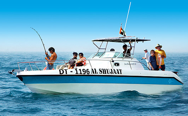 Group of Tourist fishing from an electric boat on the sea