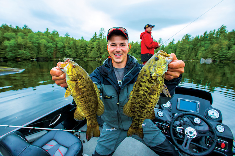 A man showing 2 fishes during his fishing session