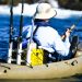 Solitary FIsherman In White Kayak.