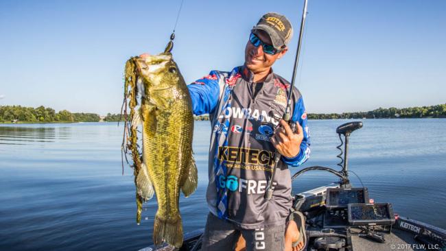 A Smiling Man Catching & Holding A Big Fish In His Hand.