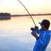 A Young man Standing In River Water & Fishing.