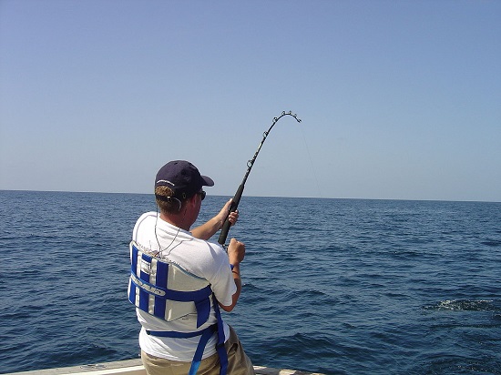 A Man Polefishing In The Deep Sea.