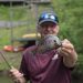 An Old Man Catched A Bream Fish And Show It To The Camera.