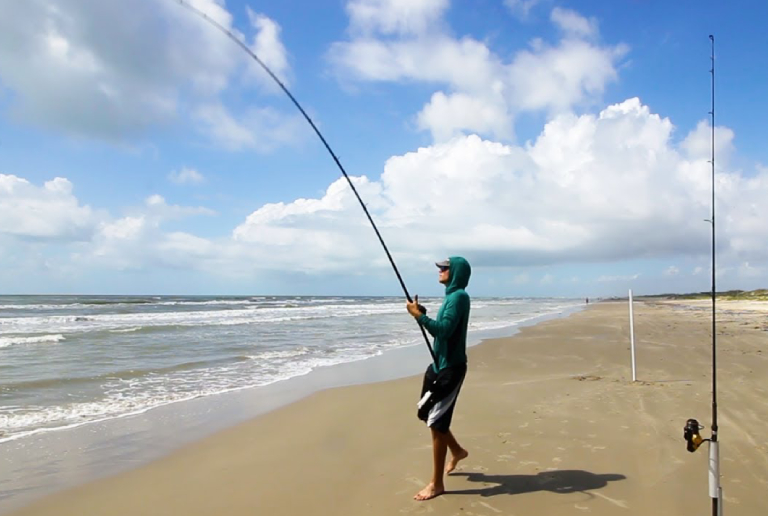 Man Casting A Fishing Line Into surf